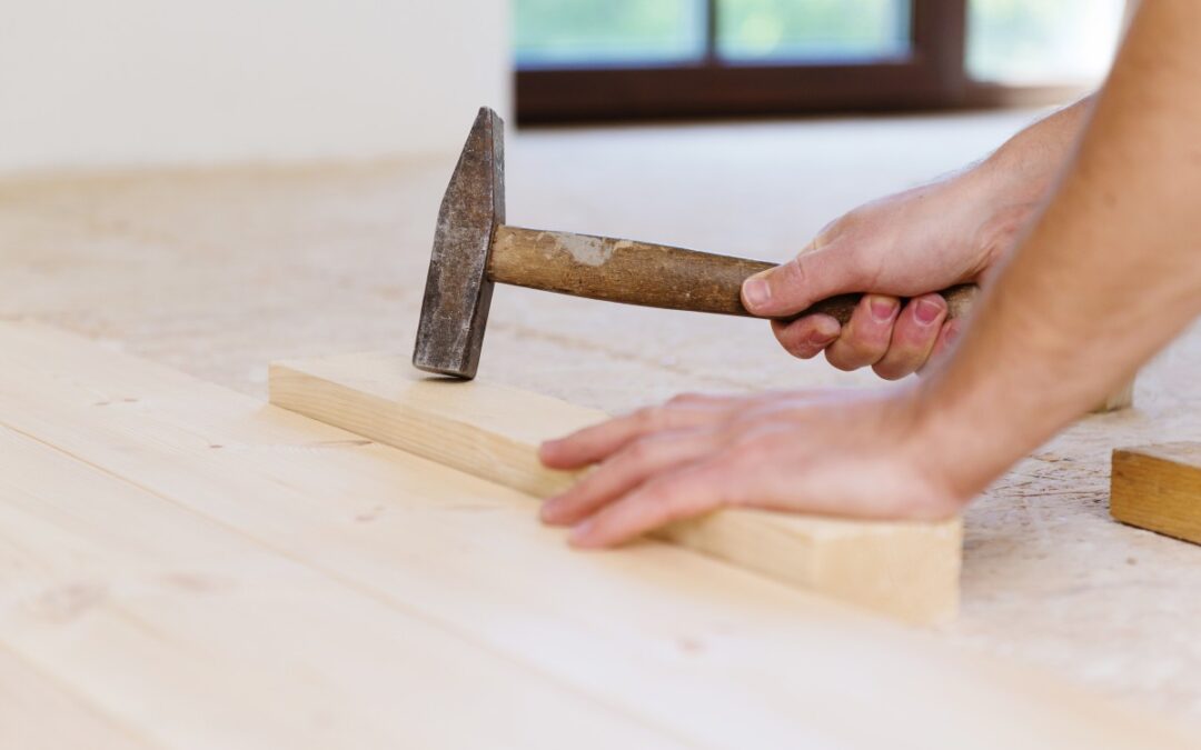 Man Tilting Wooden Flooring Block